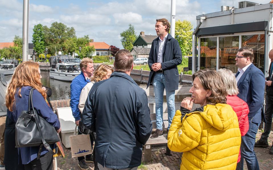 Wethouder Melvin Smit (BGL) staat de Statenleden te woord in Ossenzijl, tijdens een werkbezoek in mei.